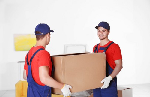 Furniture and boxes being loaded into a van for a Colyers collection