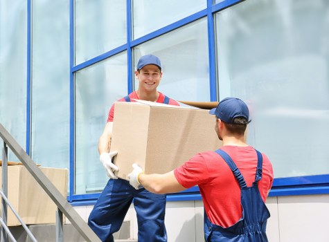 Local house removals service in Colyers with moving team and packed boxes