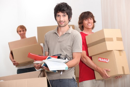 Local movers carrying furniture from a property in Colyers